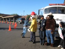 Student heads to class after shaking hands with Fire Prevention Smokey the Bear & Sparky